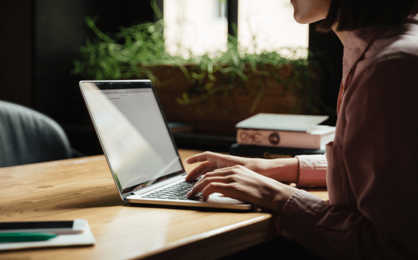 Brunette woman sitting by a table
